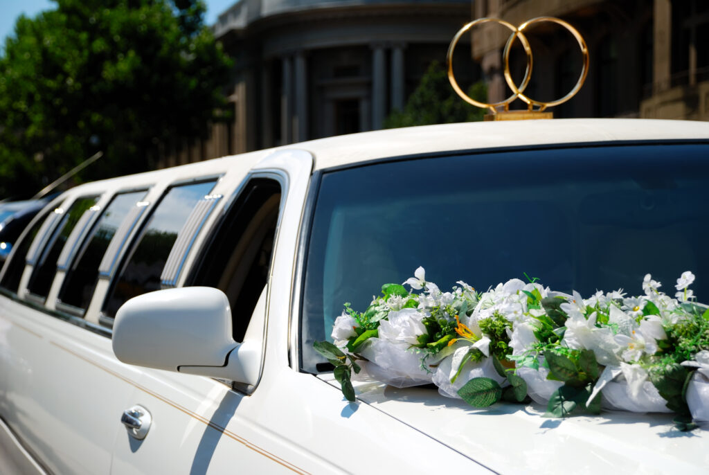 white wedding limousine decorated with flowers luxury bridal transportation Lana’s Limo service